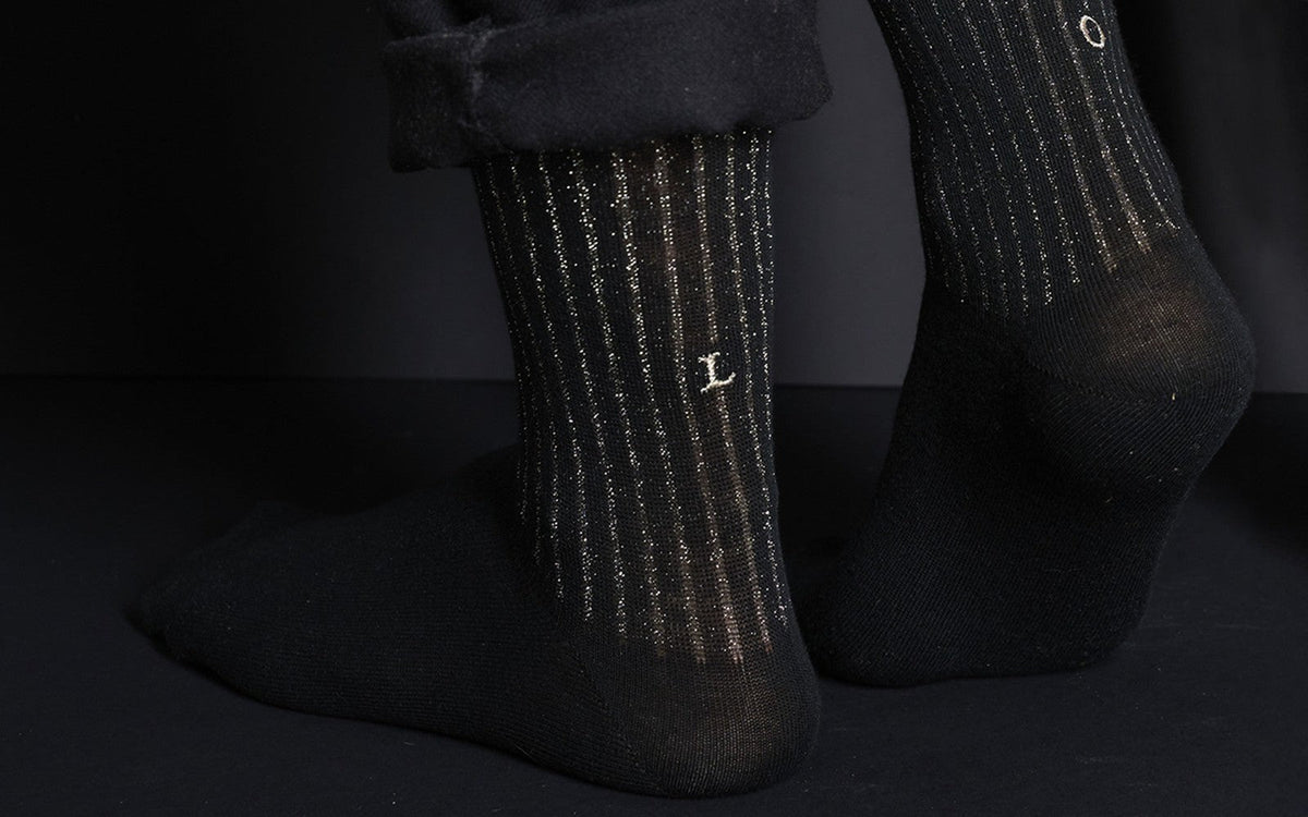 calza lurex donna con filo argento e iniziale ricamata artigianalmente in argento, primo piano a luce radente