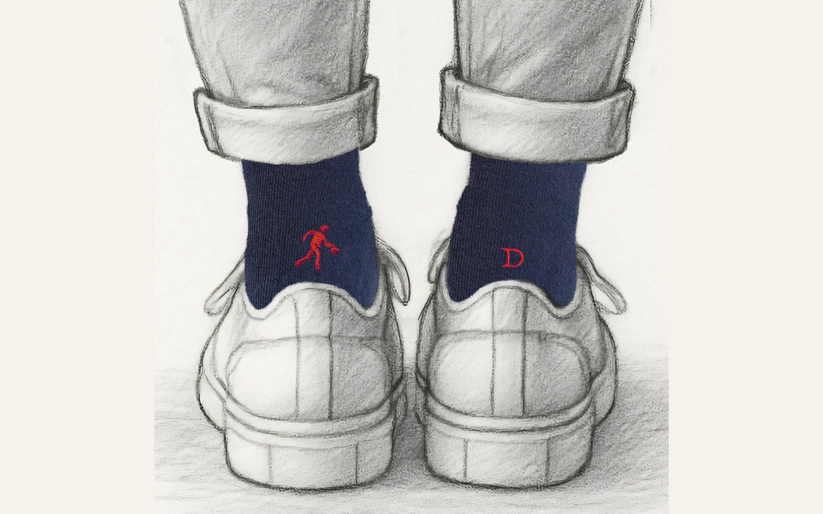 regalo per chi gioca a basket: calze blu Individual Socks con il giocatore ricamato in rosso su una calza e l'iniziale sull'altra, viste da dietro